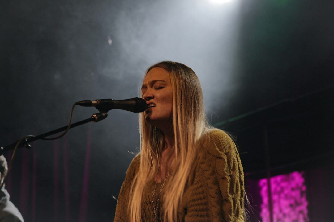 Uruguayan pop singer performing on stage with a microphone